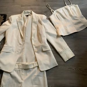 A cream colored 3 piece Womens pant suit,